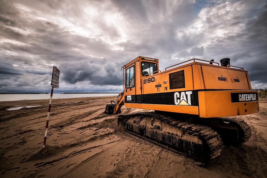 Caterpillar earth mover on beach